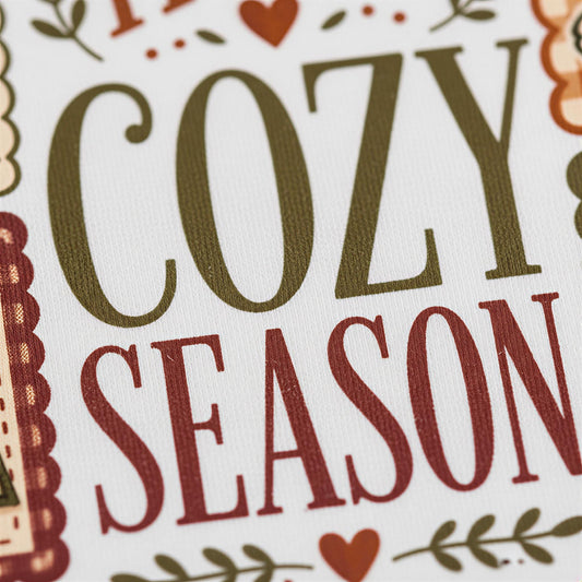 a close-up of a textured surface with the words "COZY SEASON" prominently displayed in large, bold letters.