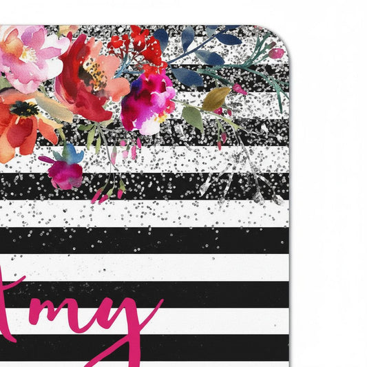 a black and white striped background with a floral design and glitter accents.