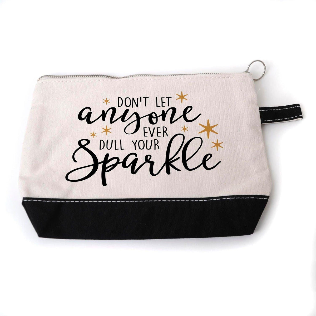 A white and black cosmetic bag with a motivational quote printed on it.