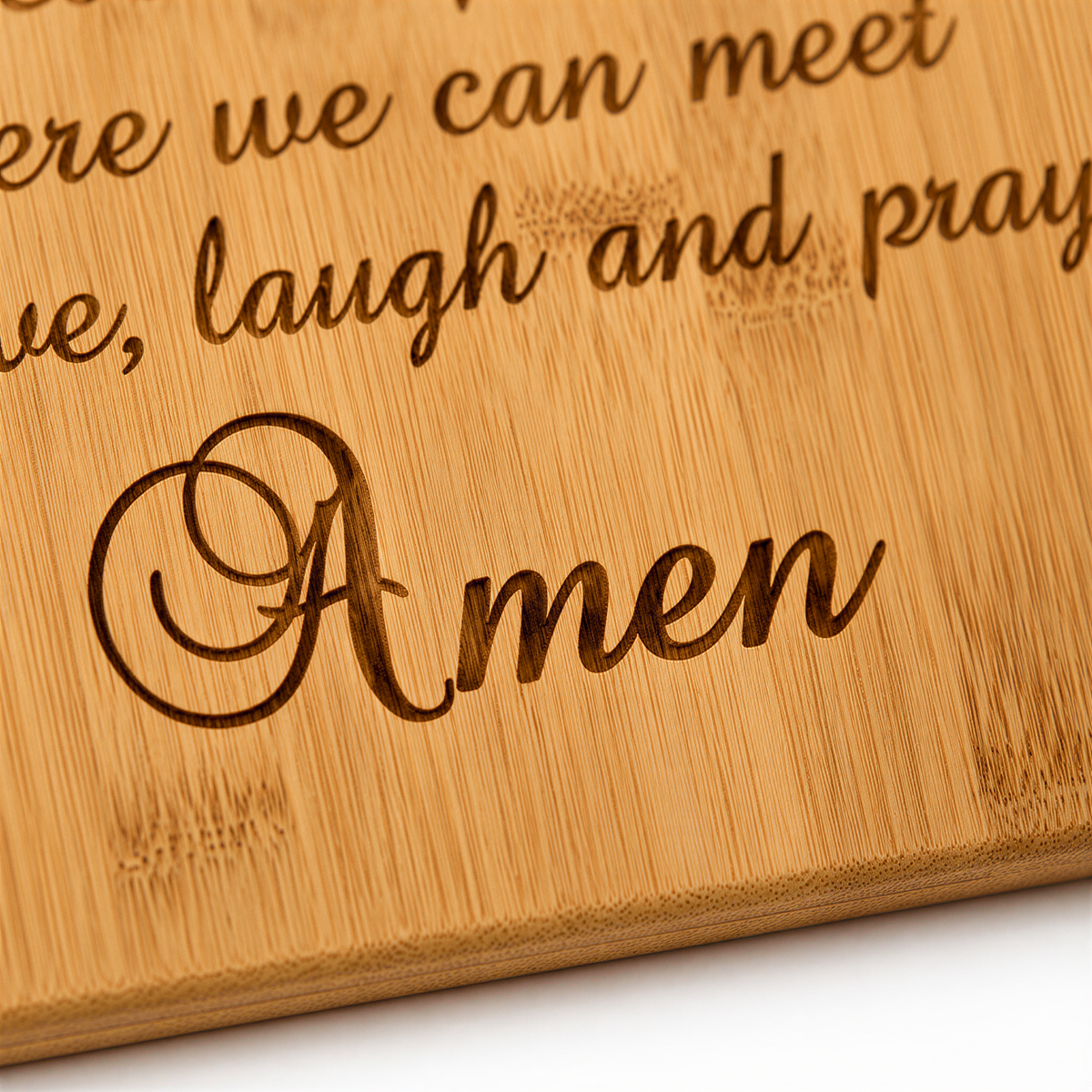 a wooden surface with the word "Amen" engraved on it.