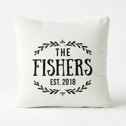 A white pillow with black text and decorative elements.