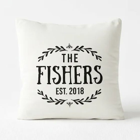 A white pillow with black text and decorative elements.