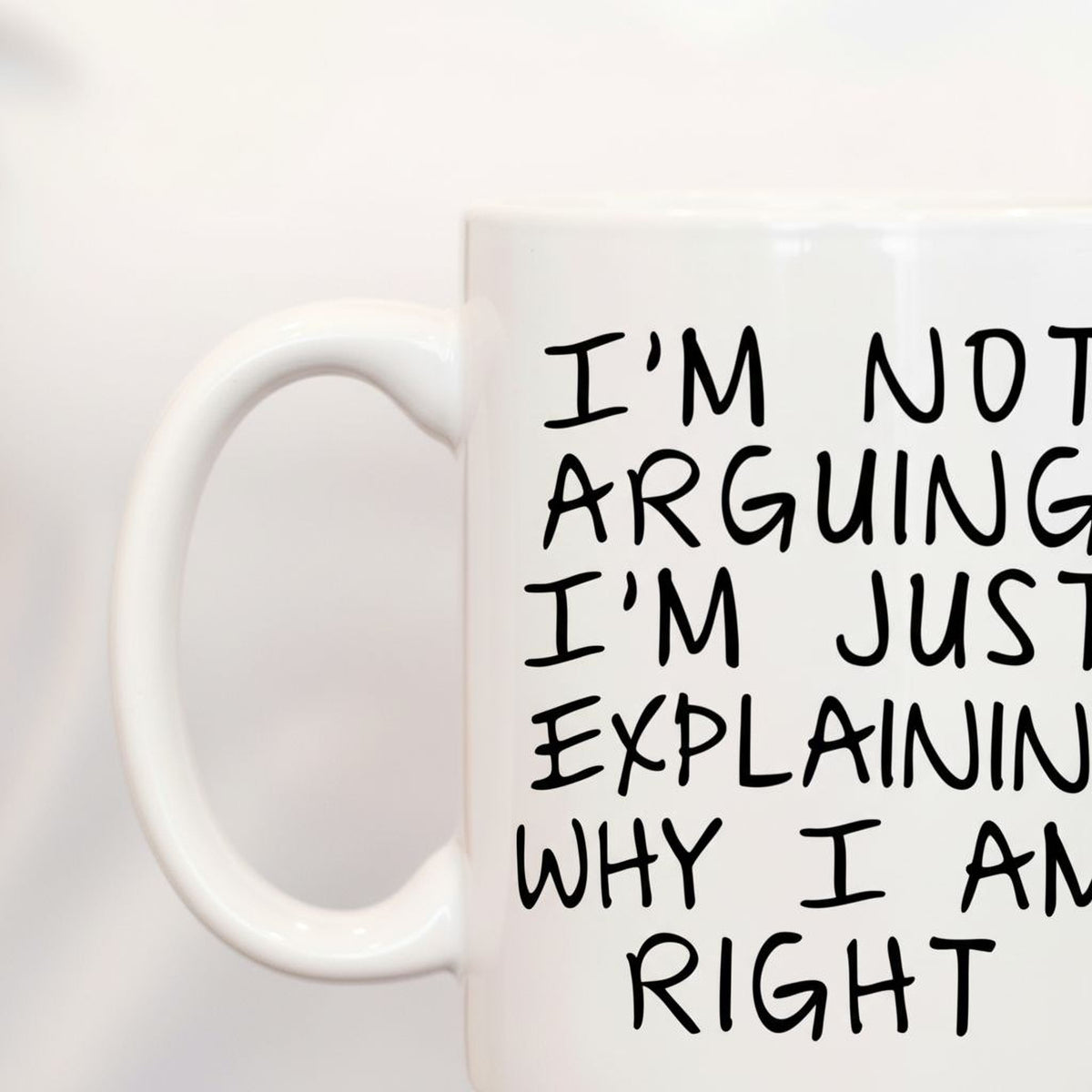 A white mug with black text on it.