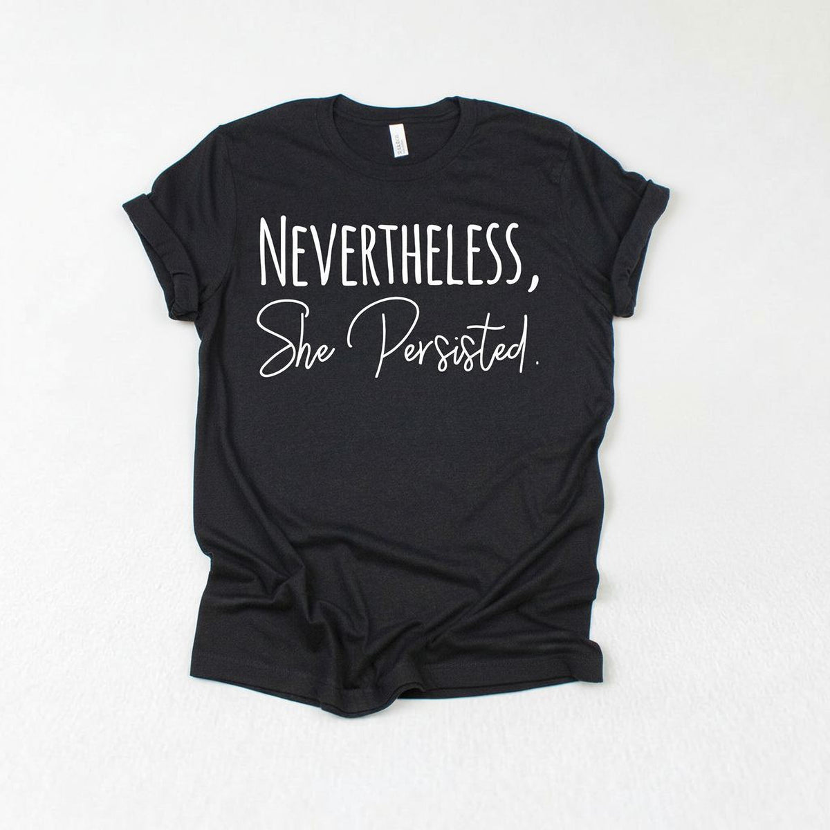 a black t-shirt with white text that reads "NEVERTHELESS, She Persisted."