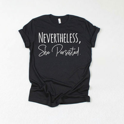 a black t-shirt with white text that reads "NEVERTHELESS, She Persisted."