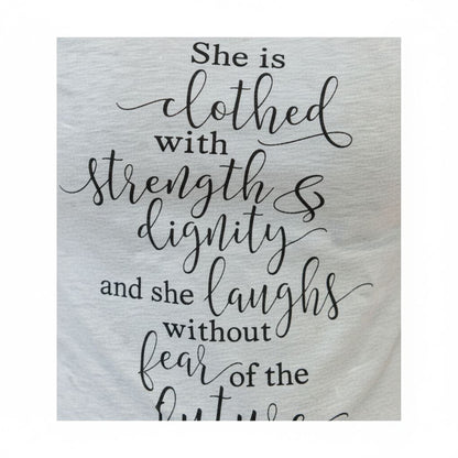 a quote in a cursive font that reads "She is clothed with strength & dignity and she laughs without fear of the fly".