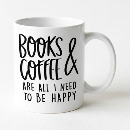 A white ceramic mug with black text that reads "BOOKS & COFFEE ARE ALL I NEED TO BE HAPPY".