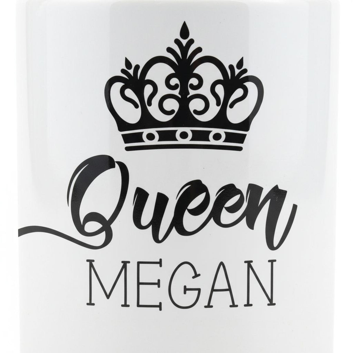 A white mug with a black crown design and the text "Queen Megan" printed on it.