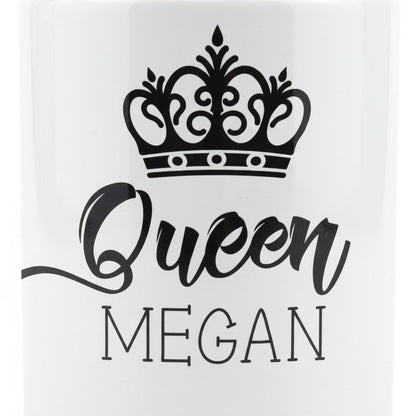 A white mug with a black crown design and the text "Queen Megan" printed on it.