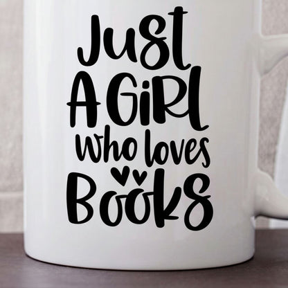A white mug with black text that reads "Just a girl who loves books".