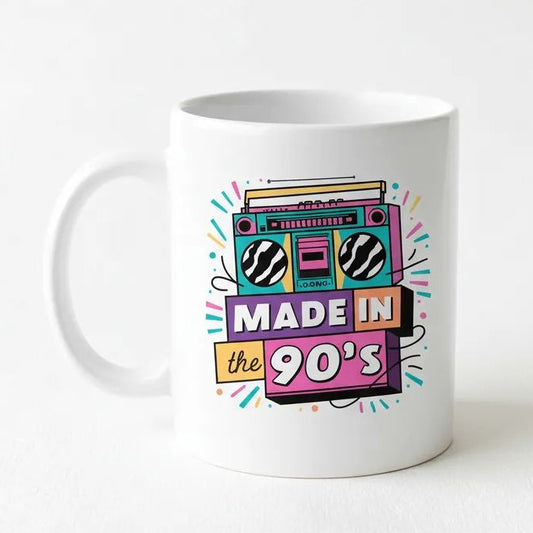 A white ceramic mug with a colorful graphic design featuring a boombox and the text "MADE IN the 90's"