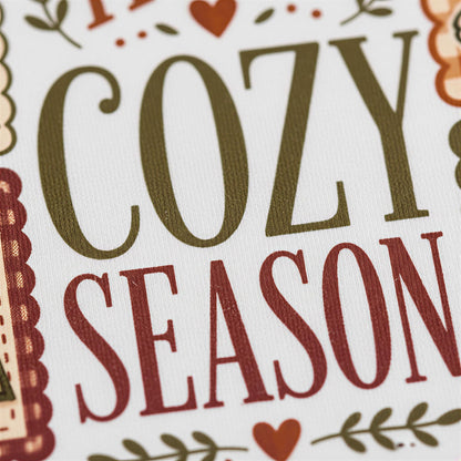 a close-up of a textured surface with the words "COZY SEASON" prominently displayed in large, bold letters.