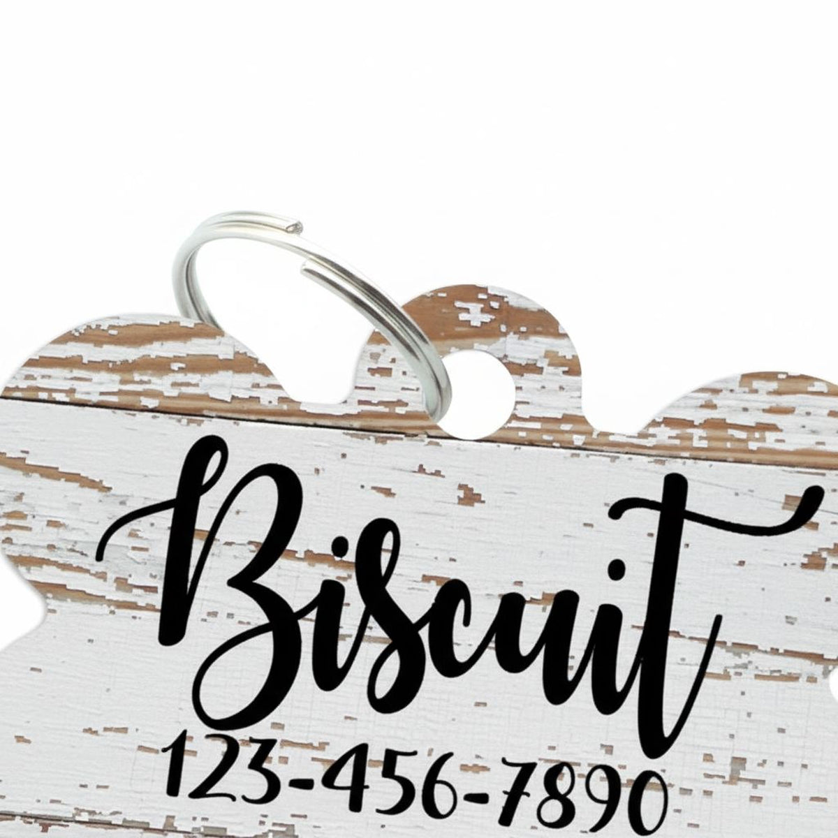A white wooden sign with the word "Biscuit" written on it, along with a phone number.