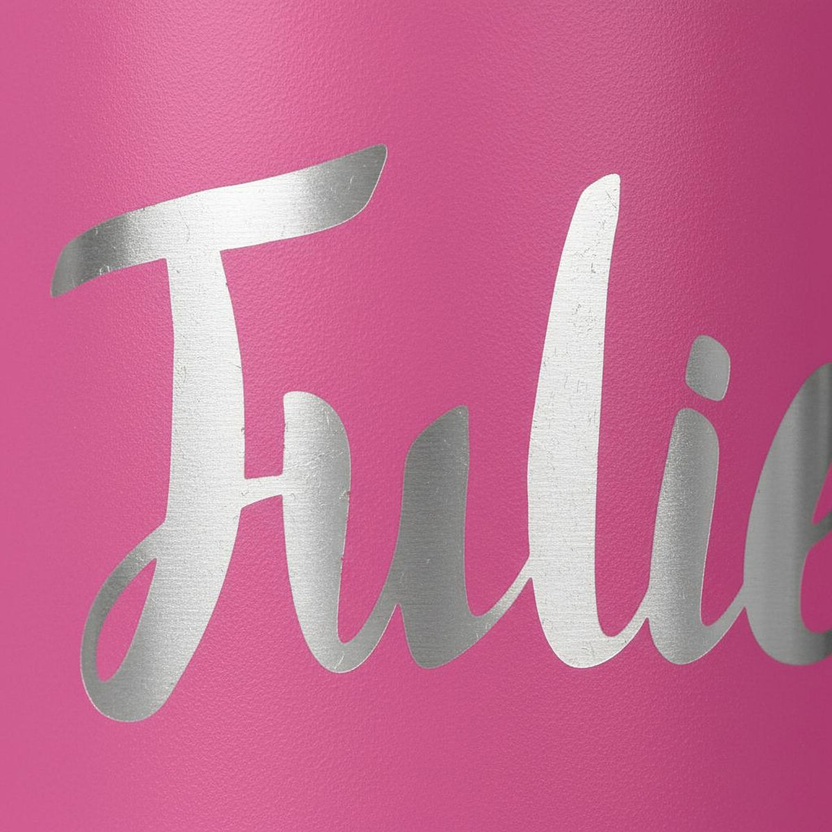 A close-up image of a pink background with the word "Julie" written in silver cursive font.