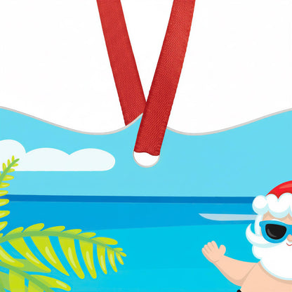 Santa Claus in a red Santa hat and sunglasses is swimming in a blue ocean, with a red ribbon tied around his neck.