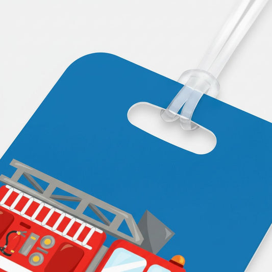 A blue luggage tag with a fire truck illustration on it.