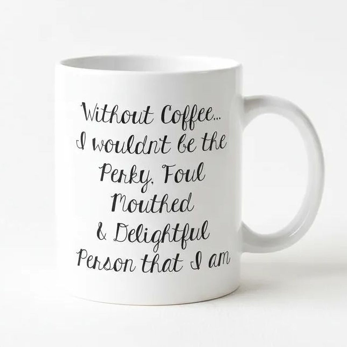 A white ceramic mug with black text printed on it.