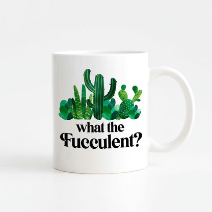 A white ceramic mug with a printed design of various cacti and succulents, along with the text "what the Fuzzy?"
