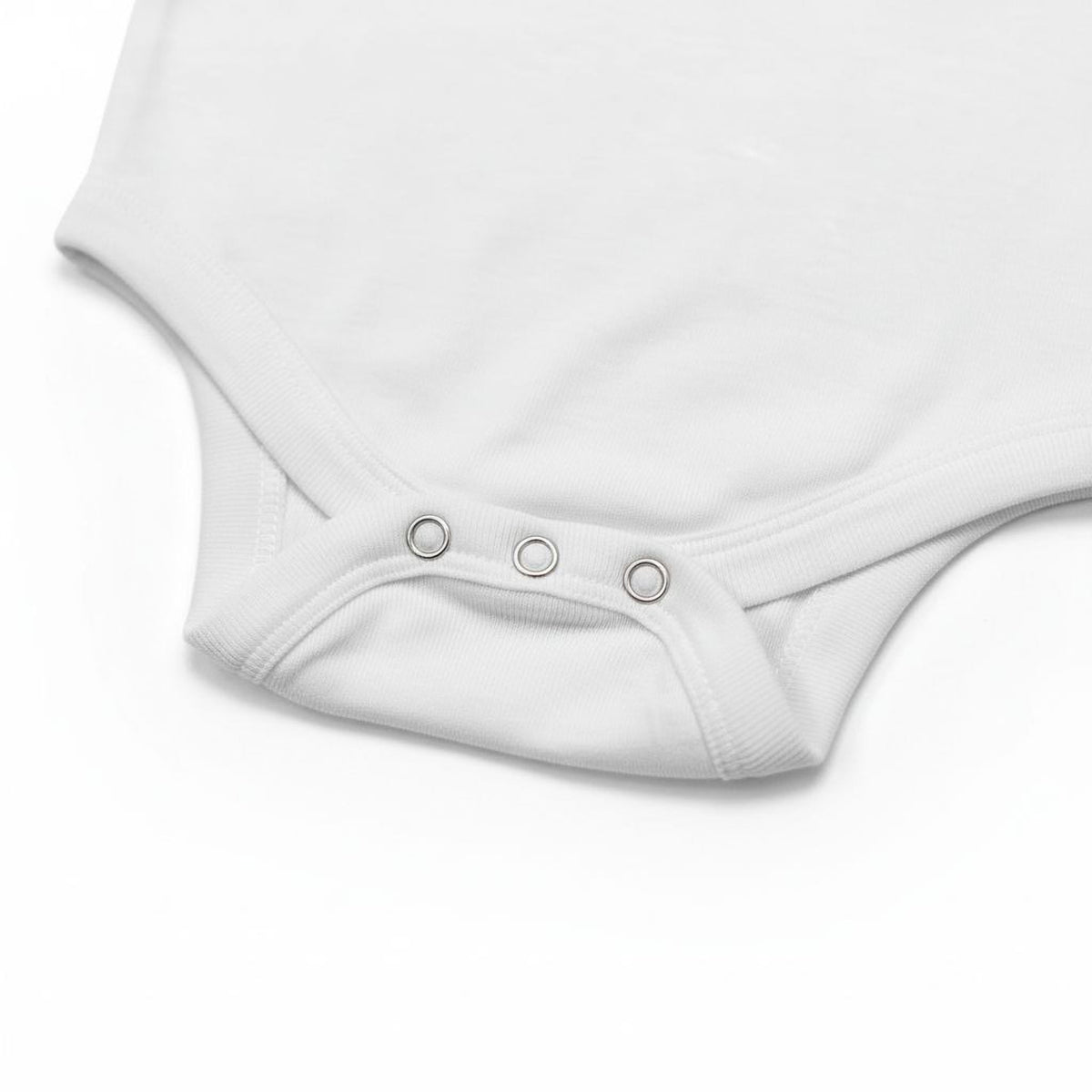 A white baby onesie with three circular buttons on the neckline.