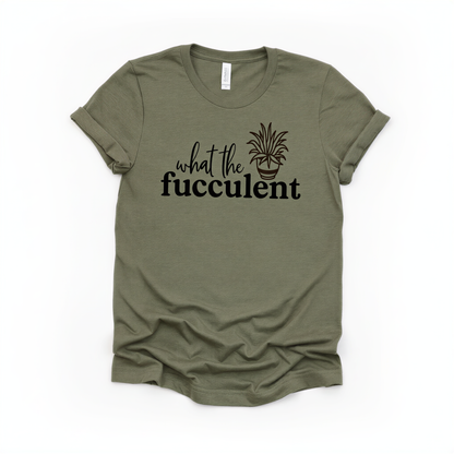 A green t-shirt with the text "what the fuchsia" printed on it, along with a graphic of a fuchsia plant.