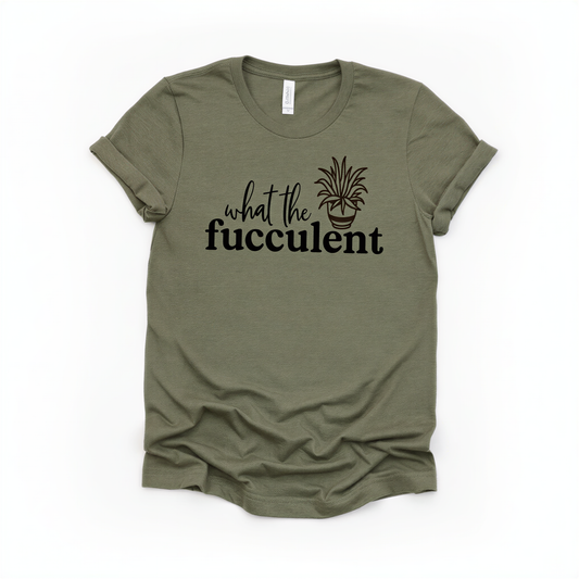A green t-shirt with the text "what the fuchsia" printed on it, along with a graphic of a fuchsia plant.