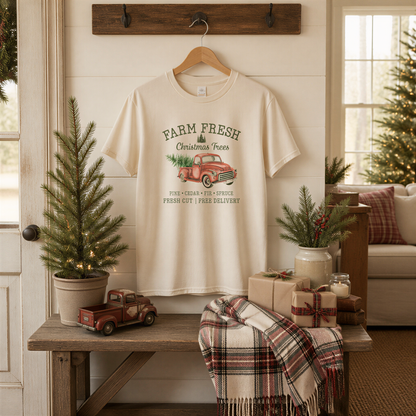 a cozy Christmas scene with a white t-shirt hanging on a wooden hanger, a red truck, a small Christmas tree, and various holiday decorations such as a candle, a gift box, and a plaid blanket.