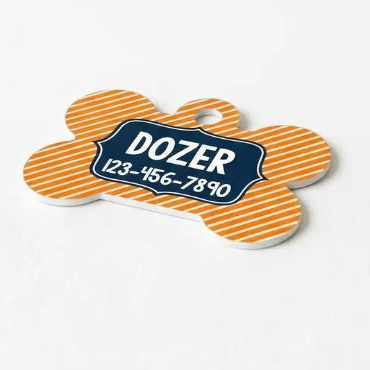 A dog name tag with a striped pattern and the name "DOZER" printed on it.