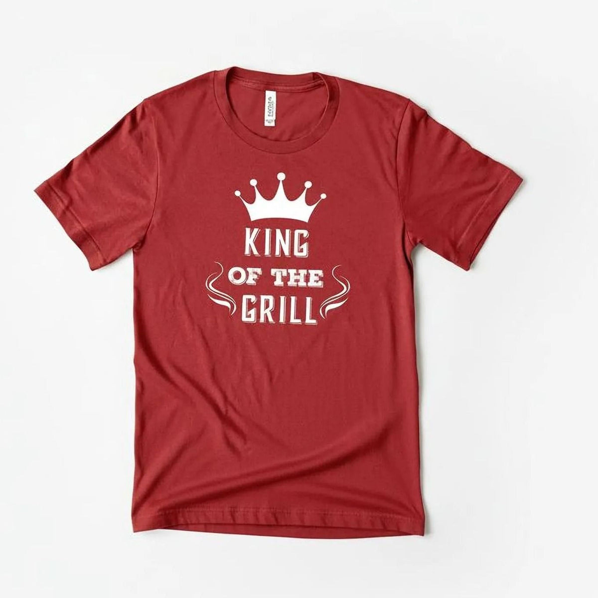 A red t-shirt with the text "KING OF THE GRILL" printed on it.