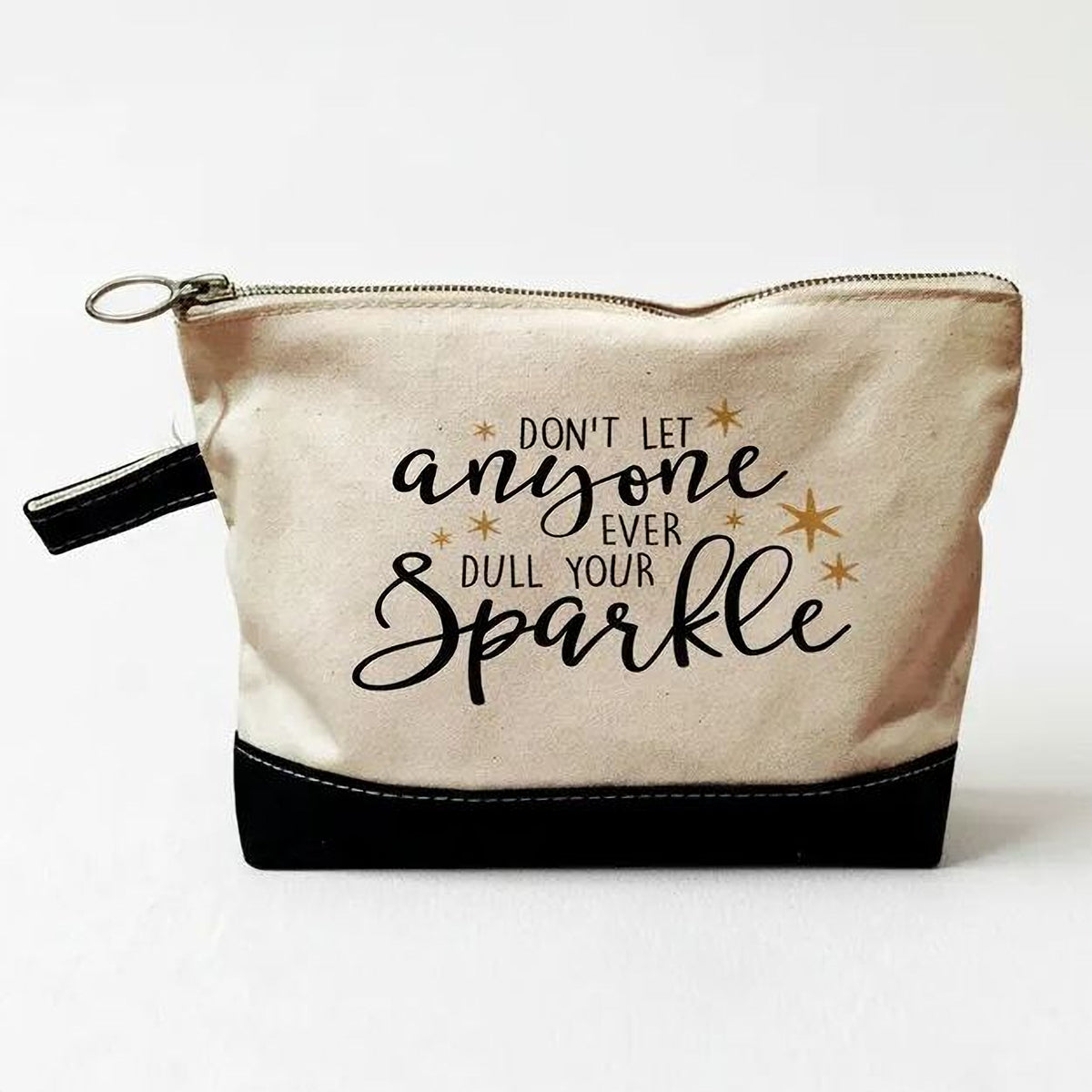 A beige and black cosmetic bag with a zipper closure and a motivational quote printed on it.