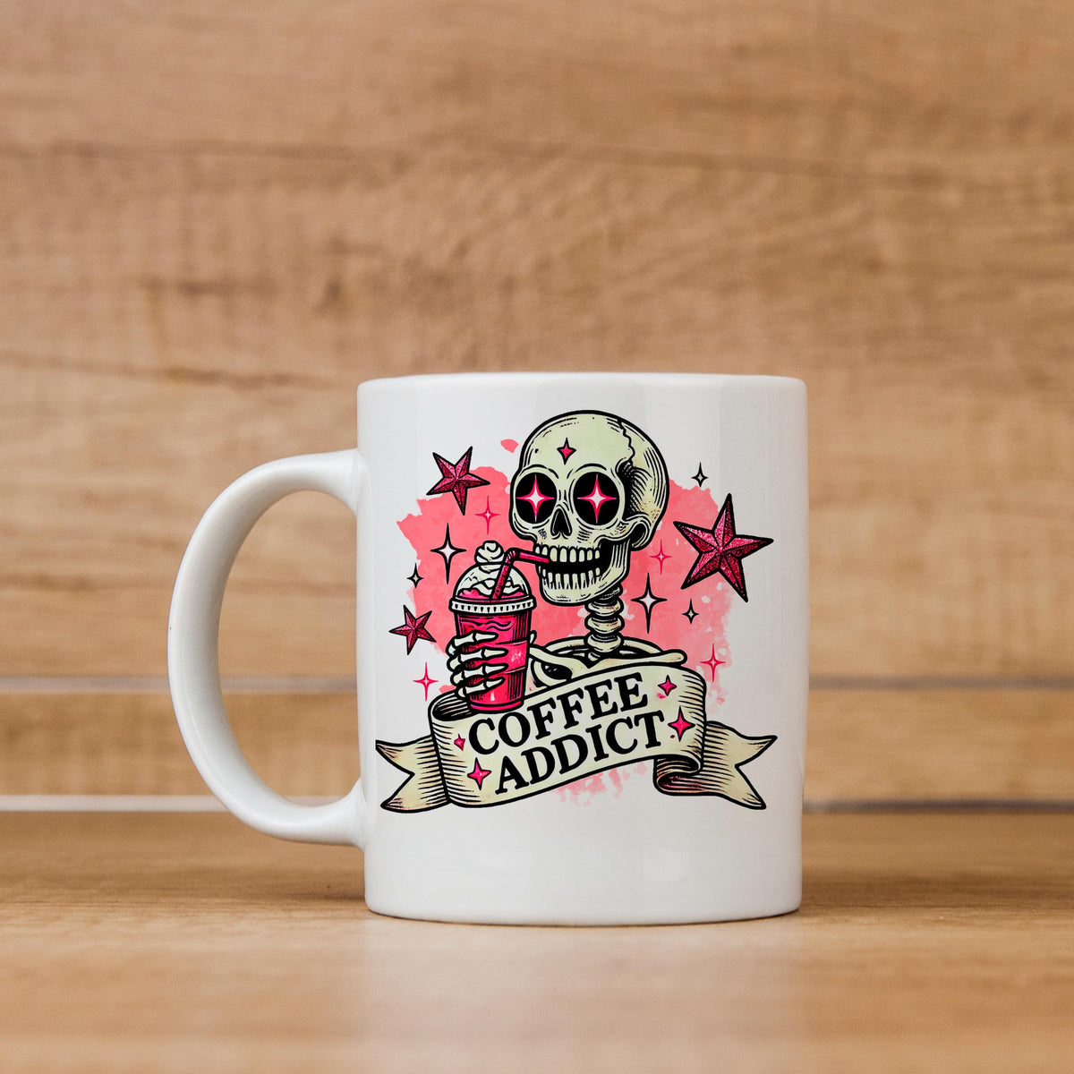 A white ceramic mug with a skull design and the text "COFFEE ADDICT" printed on it.