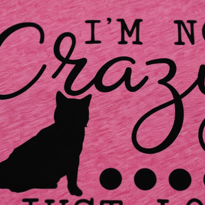 a close-up of a pink fabric with a black silhouette of a cat and the text "I'm not crazy just love" printed on it.
