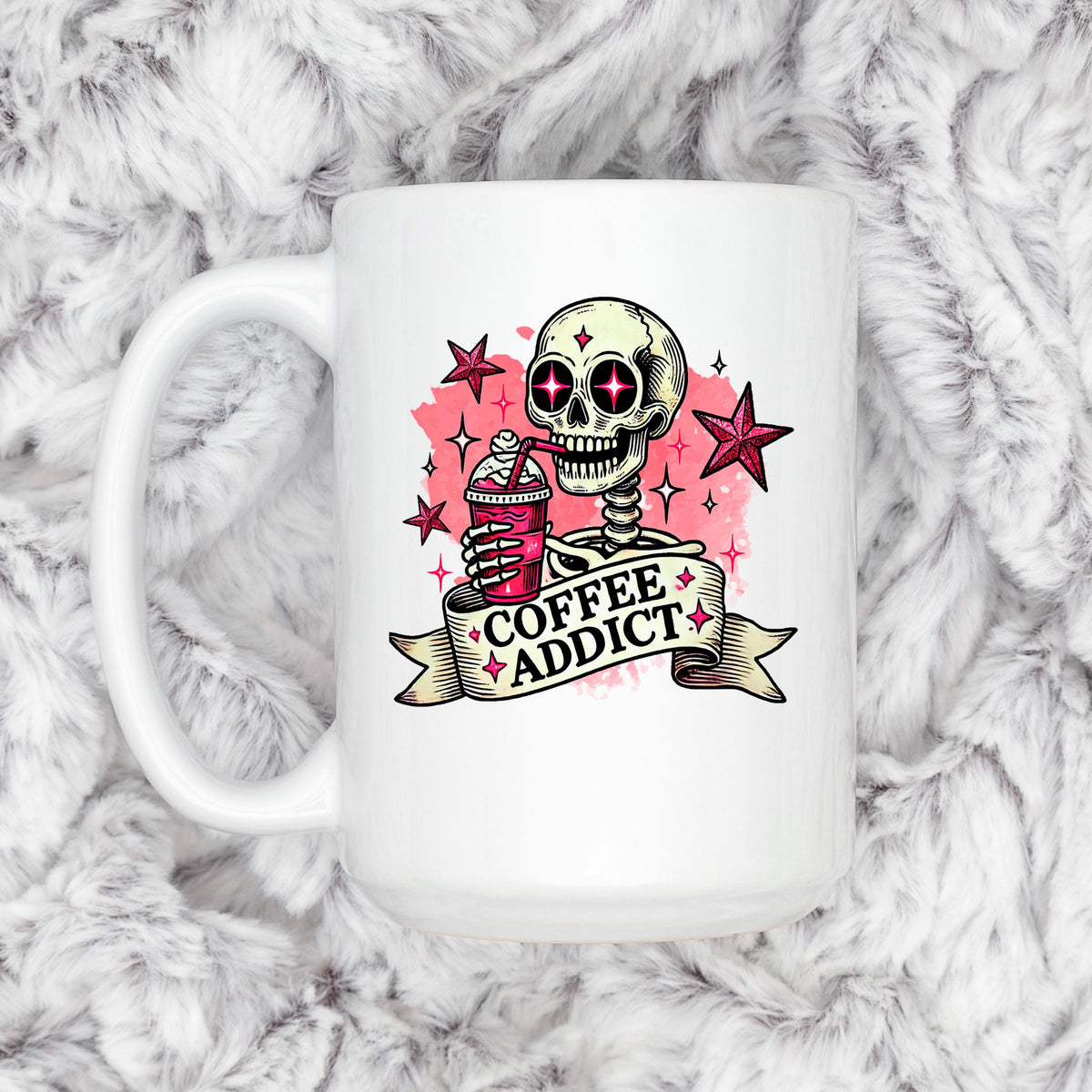 A white mug with a skull and star design, holding a coffee drink, and the text "COFFEE ADDICT" written on it.