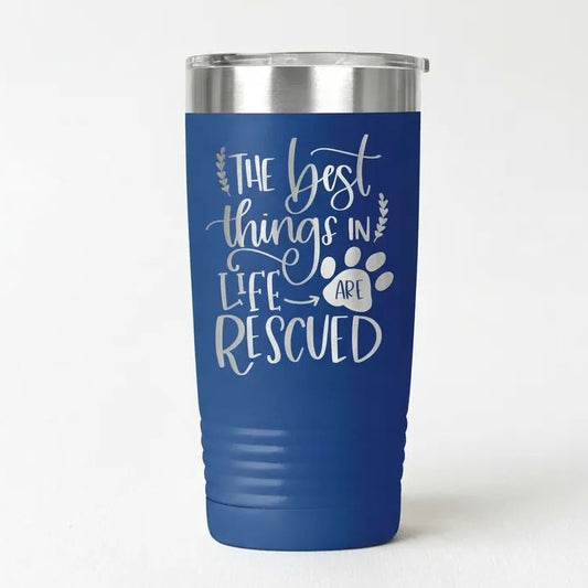 A blue insulated tumbler with a silver lid, featuring a white text design that reads "The best things in life are rescued".