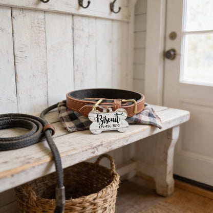 a dog collar and leash on a wooden bench, with a woven basket and a black rope nearby.