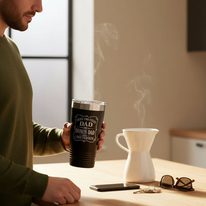 a man holding a cup of coffee while sitting at a table