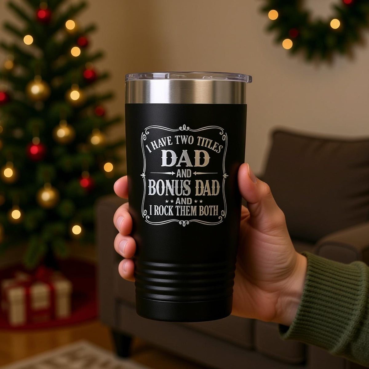 A person's hand holding a black insulated tumbler with a humorous text printed on it.