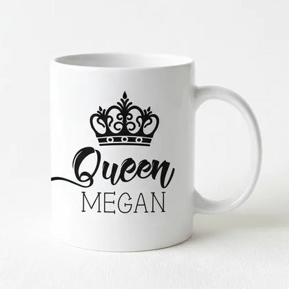 A white ceramic mug with a black crown design and the text "Queen Megan" printed on it.