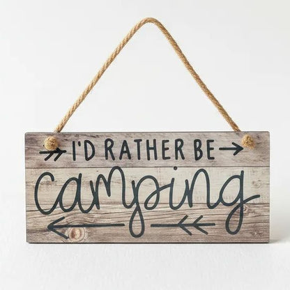 A wooden sign with the text "I'd Rather Be Camping" written on it.