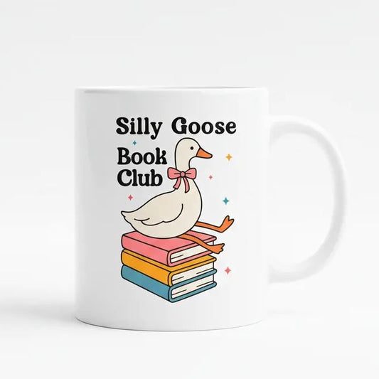A white mug with a cartoon image of a white goose sitting on a stack of colorful books, with the text "Silly Goose Book Club" written above it.