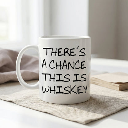 A white mug with black text printed on it, sitting on a beige cloth napkin on a table.