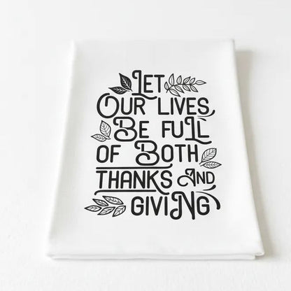 a white towel with a black and white text design that reads "Let our lives be full of both thanks and giving".