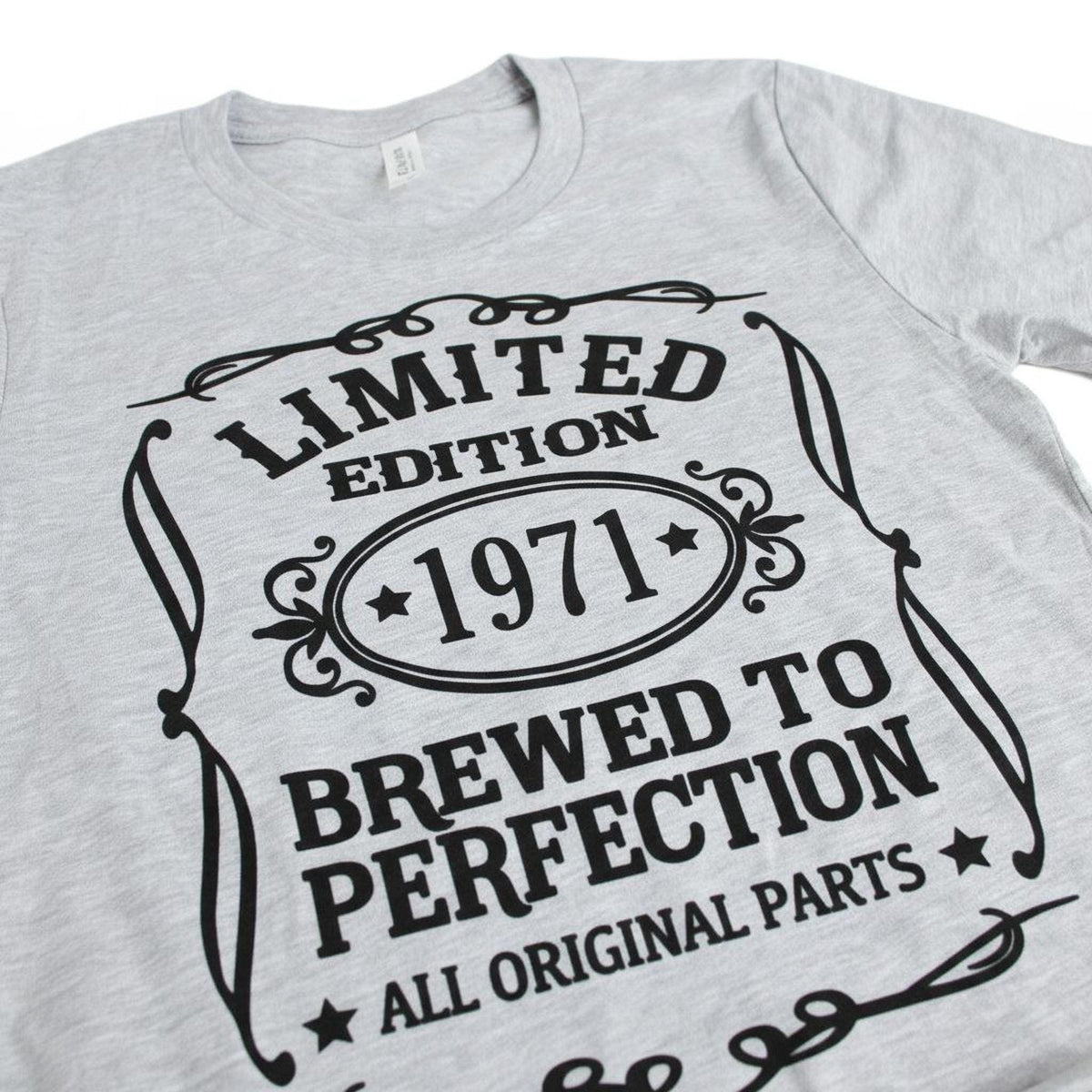 A grey t-shirt with a graphic design that reads "LIMITED EDITION 1971 BREWED TO PERFECTION ALL ORIGINAL PARTS".