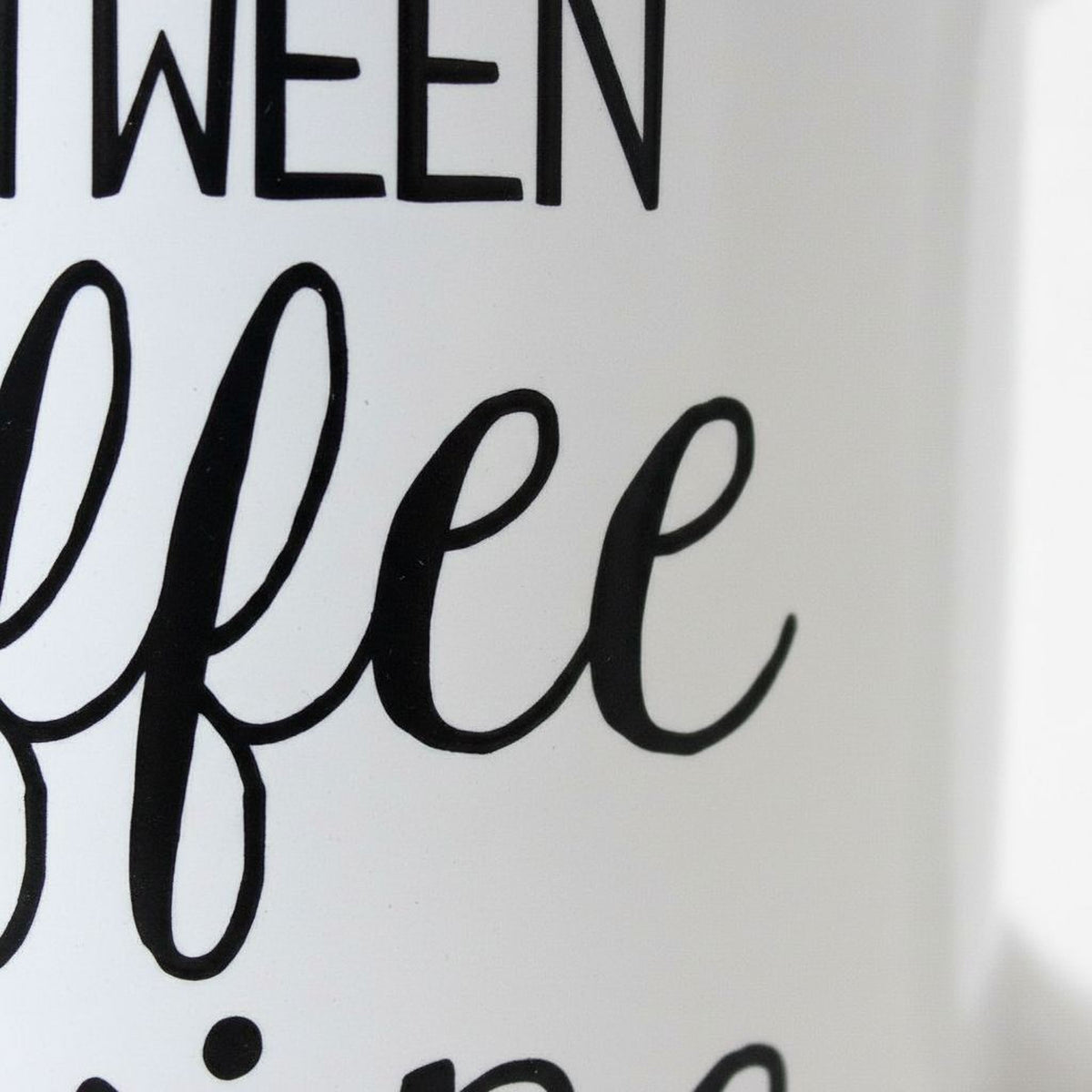 a close-up view of a white mug with black text that reads "I WERE COFFEE".