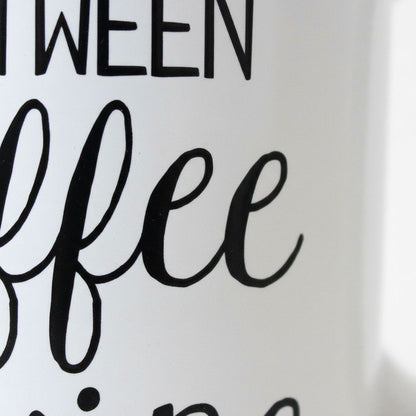 a close-up view of a white mug with black text that reads "I WERE COFFEE".