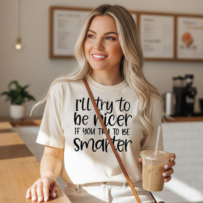 A smiling woman wearing a white t-shirt with text printed on it, holding a drink in a plastic cup.