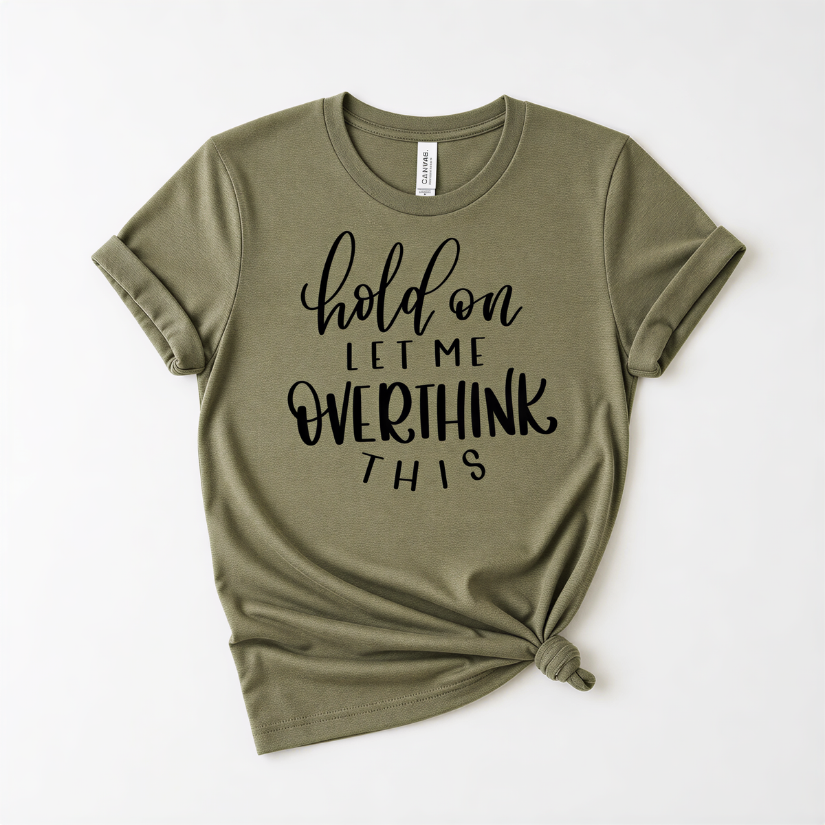 A olive green t-shirt with the text "hold on let me overthink this" printed on it.