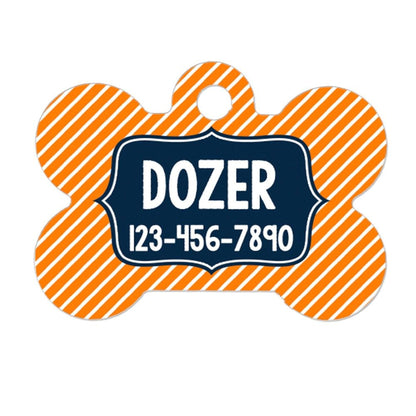 A dog tag with a striped pattern in orange and white colors. The tag has a black border and displays the name "DOZER" in white text.