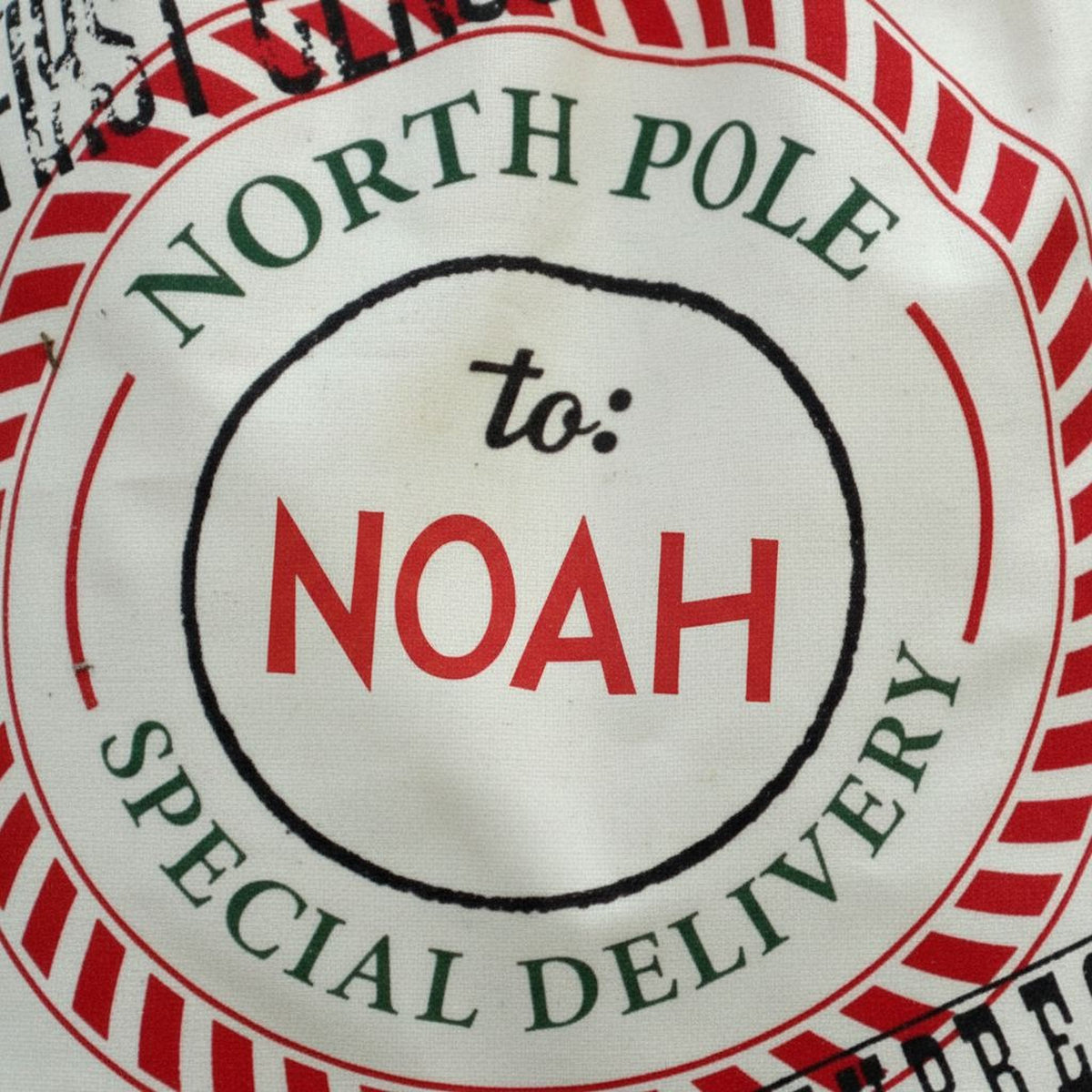 A close-up of a circular label with text and graphics, including the words "NORTH P Pole" and "to: NOAH SPECIAL DELIVERY".