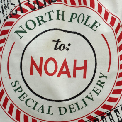 A close-up of a circular label with text and graphics, including the words "NORTH P Pole" and "to: NOAH SPECIAL DELIVERY".