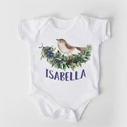 A white baby onesie with a bird illustration and the name "Isabella" printed on it.